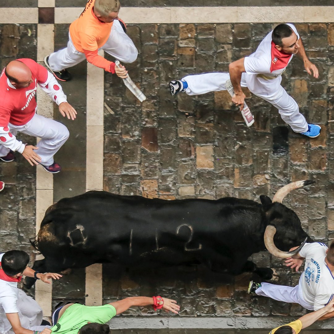 Watch or even participate in the running of the bulls in Pamplona Spain